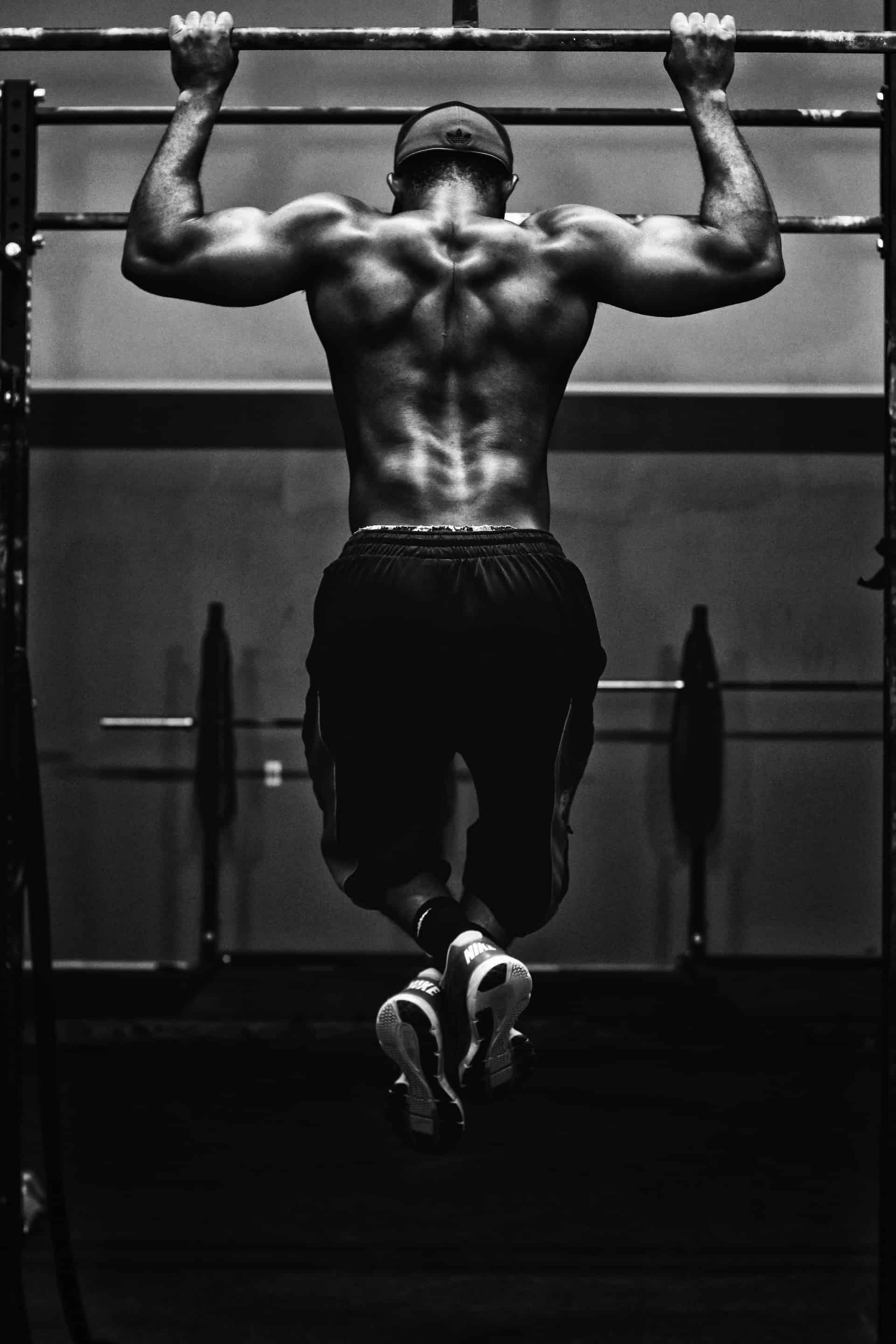 a man doing pull-ups on the horizontal bar